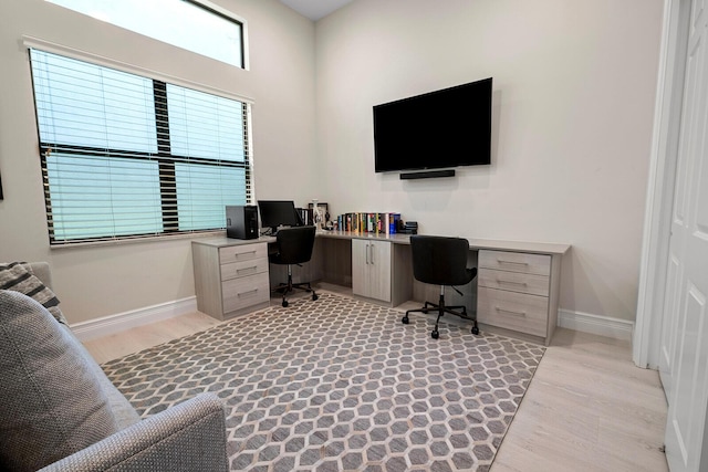 office area with light hardwood / wood-style floors