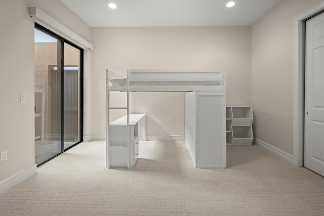 unfurnished bedroom featuring light carpet