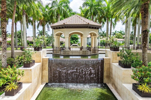 view of home's community with a gazebo and a water view