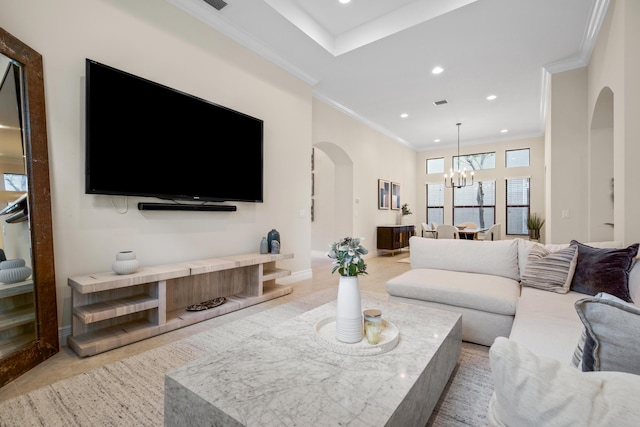 living room featuring crown molding and a notable chandelier