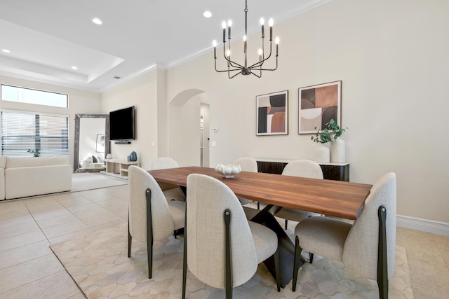 tiled dining area featuring a notable chandelier and crown molding