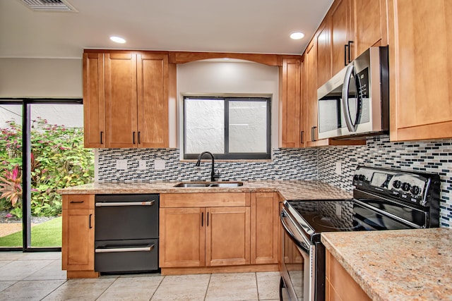 kitchen with light stone countertops, tasteful backsplash, sink, black electric range oven, and light tile patterned flooring