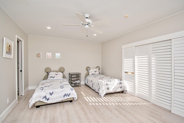 bedroom with light hardwood / wood-style floors and ceiling fan