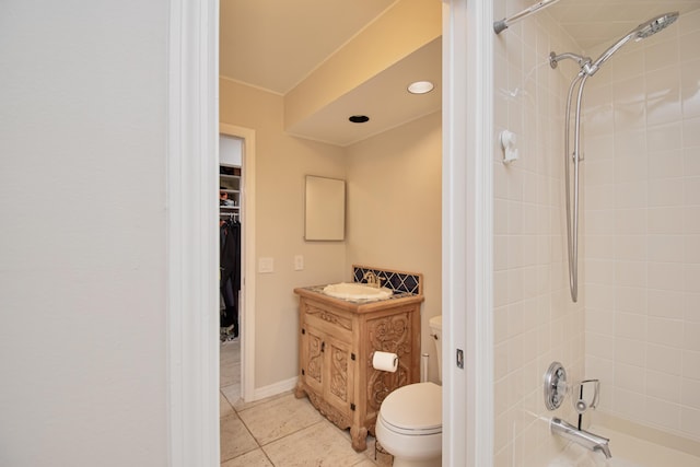 full bathroom with toilet, vanity, tile patterned floors, and tiled shower / bath