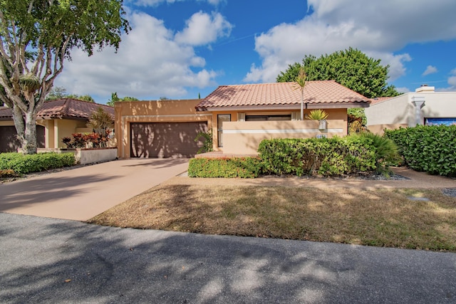 mediterranean / spanish-style house with a garage