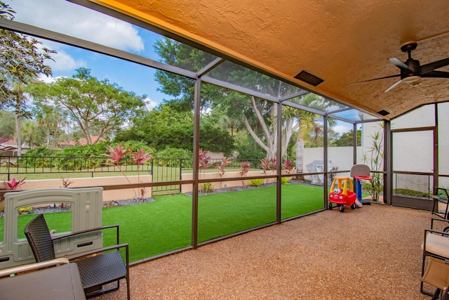 sunroom / solarium featuring ceiling fan