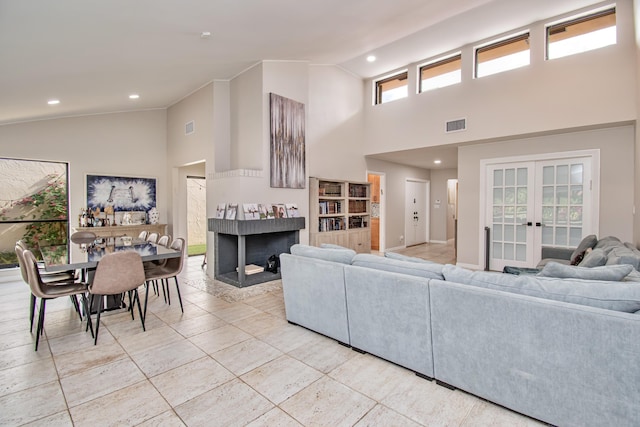 living room with high vaulted ceiling and french doors