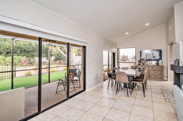 tiled dining space with lofted ceiling