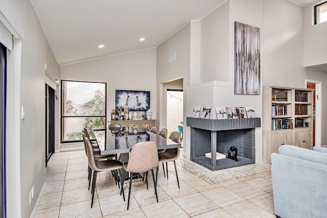 dining space featuring high vaulted ceiling