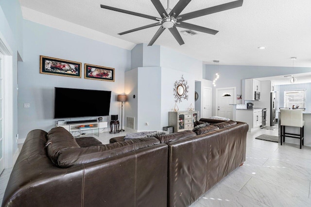 living room featuring a textured ceiling, ceiling fan, and lofted ceiling