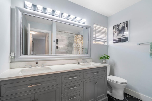 bathroom featuring a shower with shower curtain, vanity, toilet, and tile patterned flooring