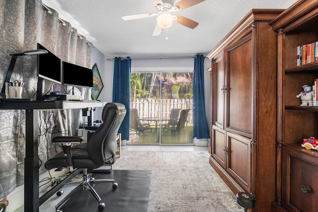 home office with ceiling fan, light colored carpet, and a textured ceiling