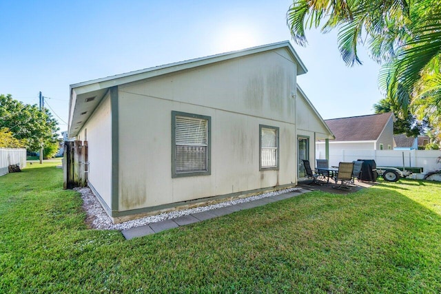 back of house featuring a yard