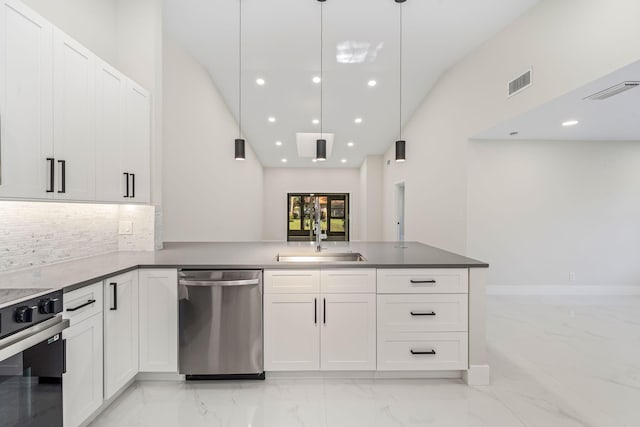 kitchen with white cabinetry, sink, hanging light fixtures, backsplash, and appliances with stainless steel finishes