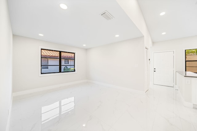 unfurnished room featuring plenty of natural light