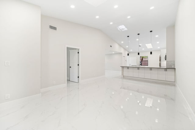 unfurnished living room with vaulted ceiling