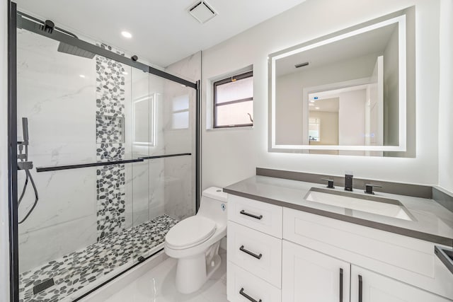 bathroom with vanity, toilet, and walk in shower