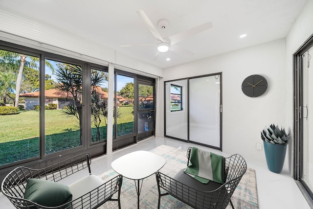 sunroom featuring ceiling fan