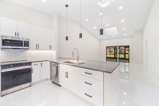 kitchen with white cabinets, sink, hanging light fixtures, a skylight, and stainless steel appliances