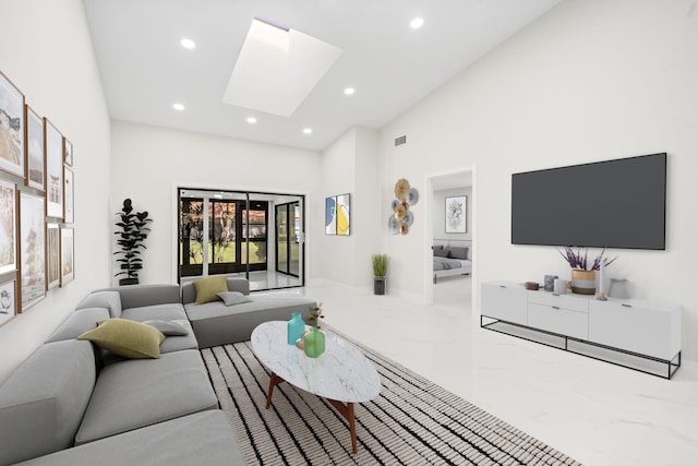 living room featuring a skylight and high vaulted ceiling