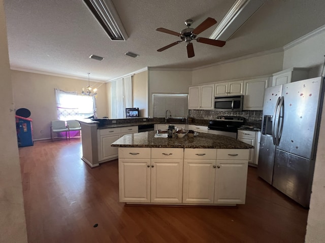 kitchen with white cabinets, appliances with stainless steel finishes, and hanging light fixtures