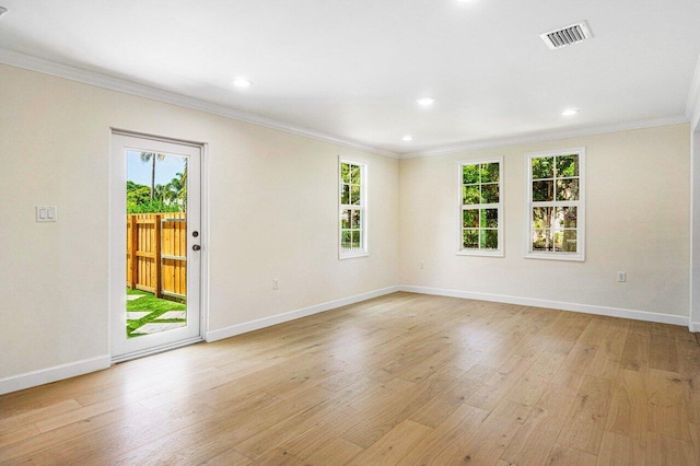 unfurnished room with light wood-type flooring, ornamental molding, and a wealth of natural light