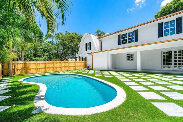 view of swimming pool featuring a patio and a lawn