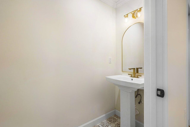 bathroom with crown molding and sink