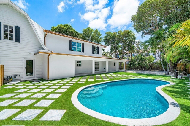 back of house with a yard and a patio