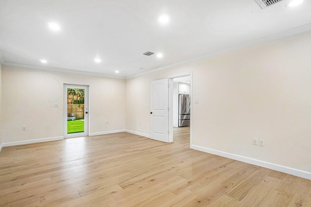 spare room with light hardwood / wood-style floors and ornamental molding