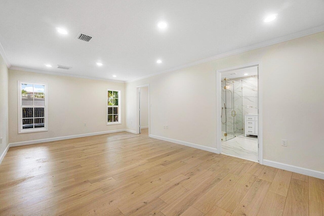 spare room with plenty of natural light, crown molding, and light hardwood / wood-style flooring