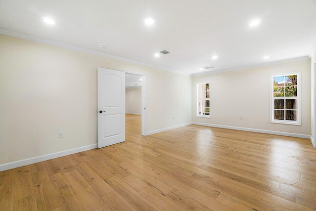 unfurnished room with ornamental molding and light hardwood / wood-style flooring