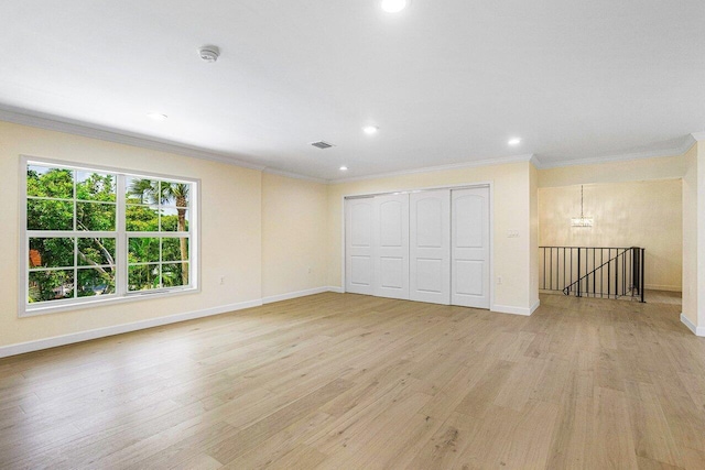 interior space with light wood-type flooring and crown molding