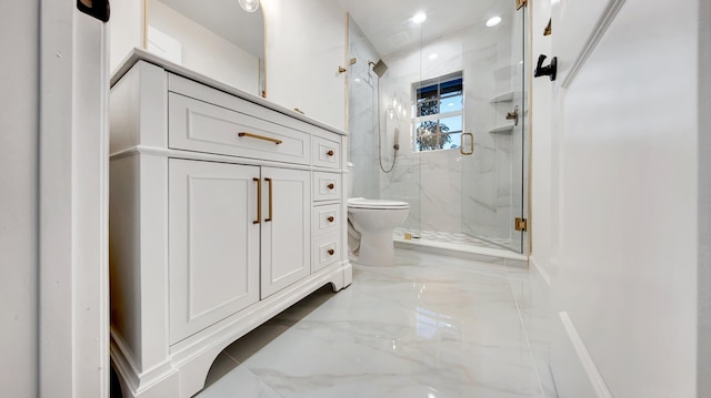 bathroom featuring vanity, toilet, and a shower with door