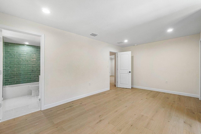 spare room with light hardwood / wood-style floors