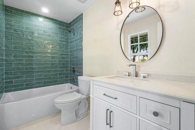 full bathroom with tile patterned floors, vanity, tiled shower / bath combo, and toilet