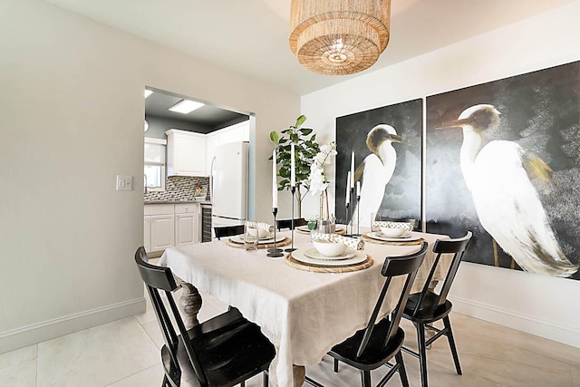 dining space featuring light tile patterned flooring