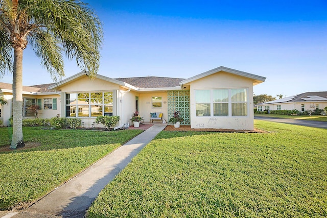 ranch-style home with a front lawn