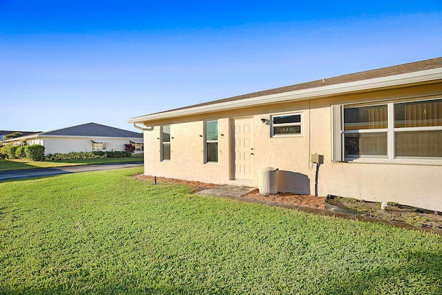 view of property exterior with a lawn