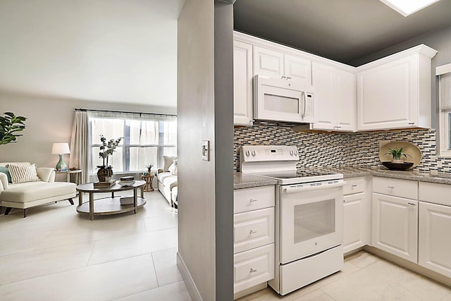 kitchen featuring tasteful backsplash, white cabinetry, and white appliances