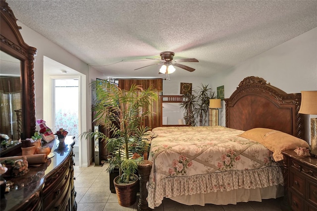 bedroom featuring light tile patterned floors, a textured ceiling, and ceiling fan