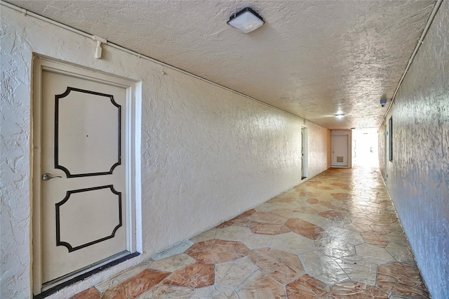 hallway with a textured ceiling