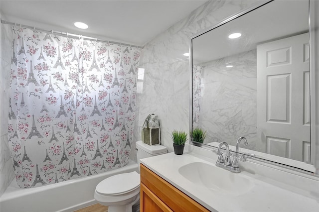 full bathroom featuring vanity, shower / tub combo, and toilet