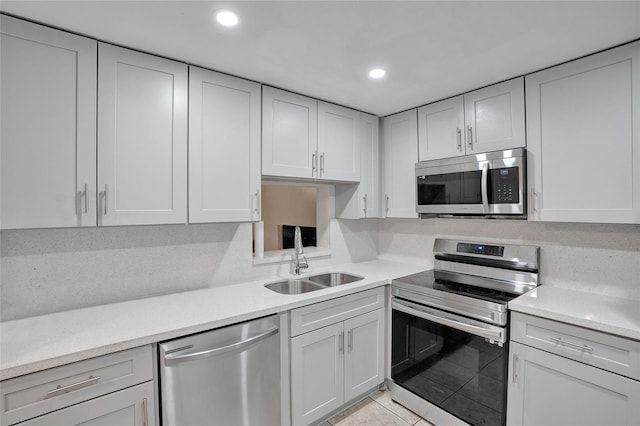 kitchen featuring sink, light tile patterned floors, and appliances with stainless steel finishes