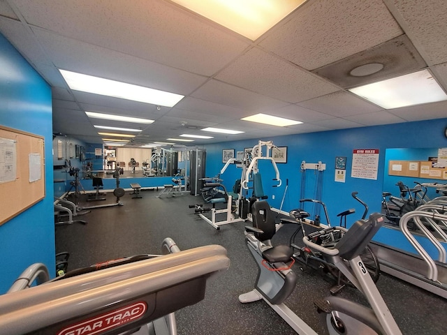 gym with a paneled ceiling