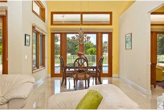 dining room featuring a notable chandelier, a healthy amount of sunlight, and french doors