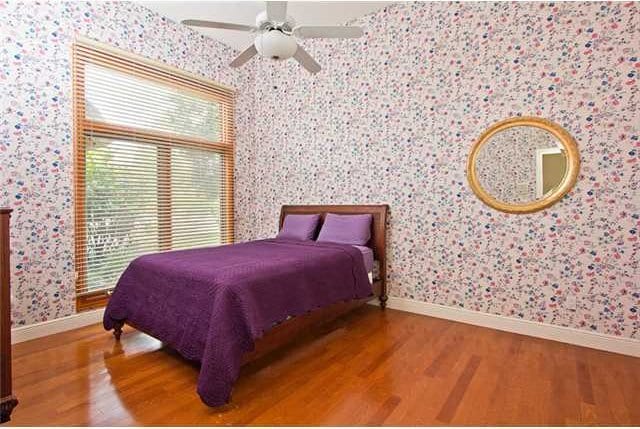 bedroom featuring hardwood / wood-style floors and ceiling fan