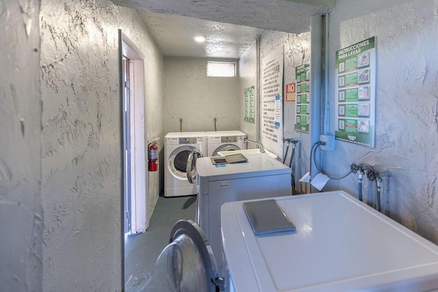 washroom featuring separate washer and dryer and a textured ceiling