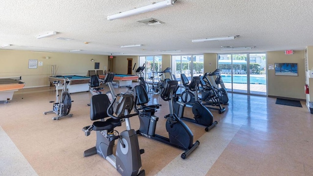 gym with a textured ceiling