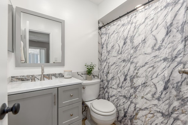 bathroom with a shower with curtain, vanity, toilet, and tile walls